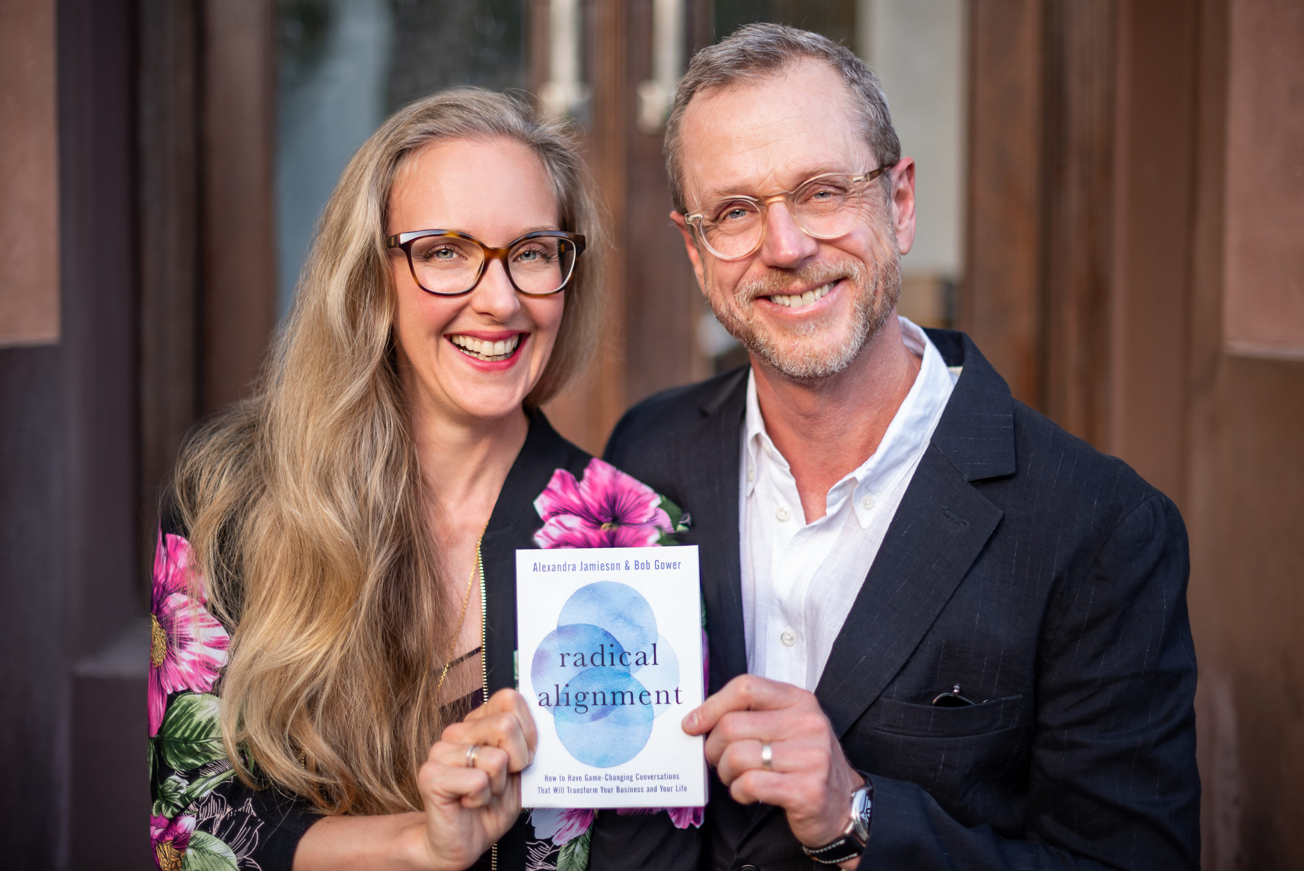 Alexandra Jamieson and Bob Gower hold a copy of their new book, Radical Alignment